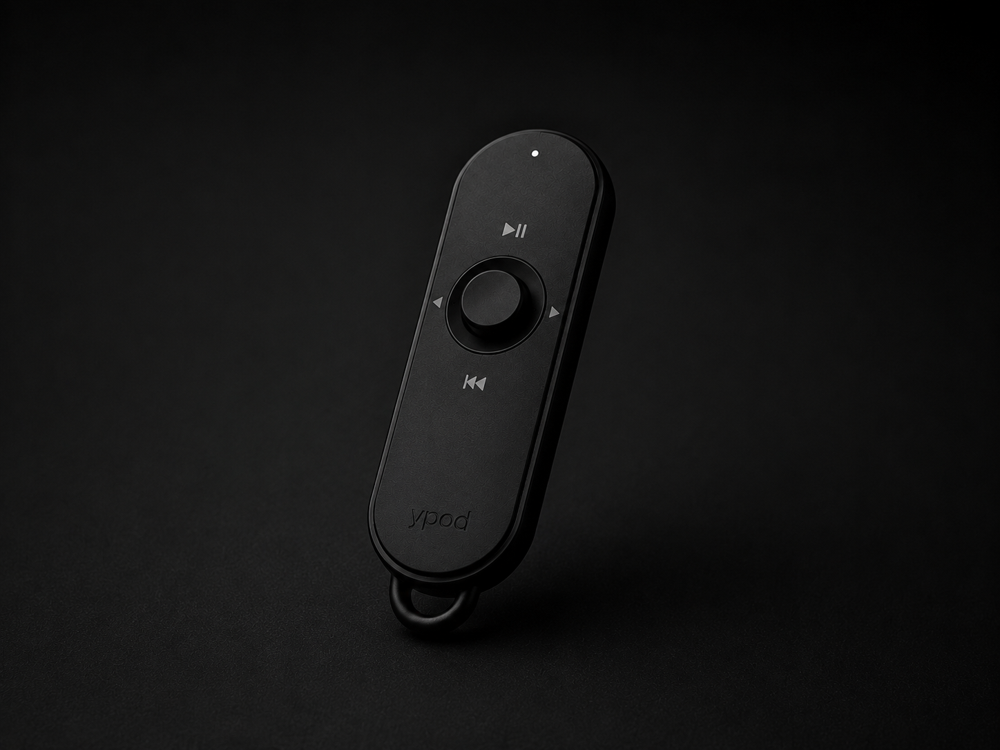 matte black ypod remote controller on a dark surface